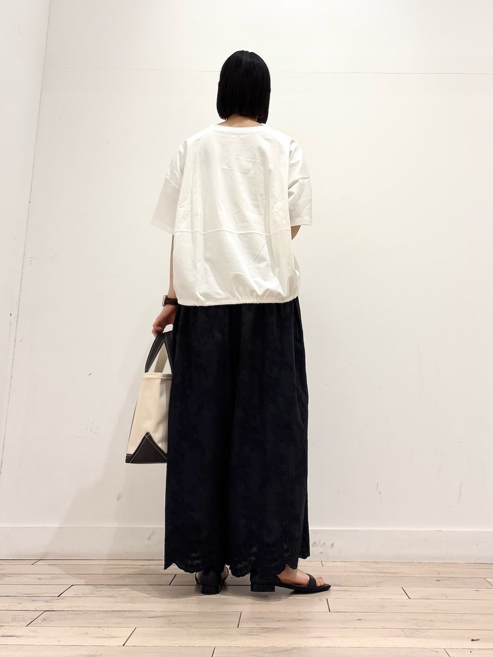 ホワイト系のTシャツ/カットソー、ブラック系のその他パンツ、グレー系のトートバッグを着用したレディースの春コーディネートの4枚目の写真