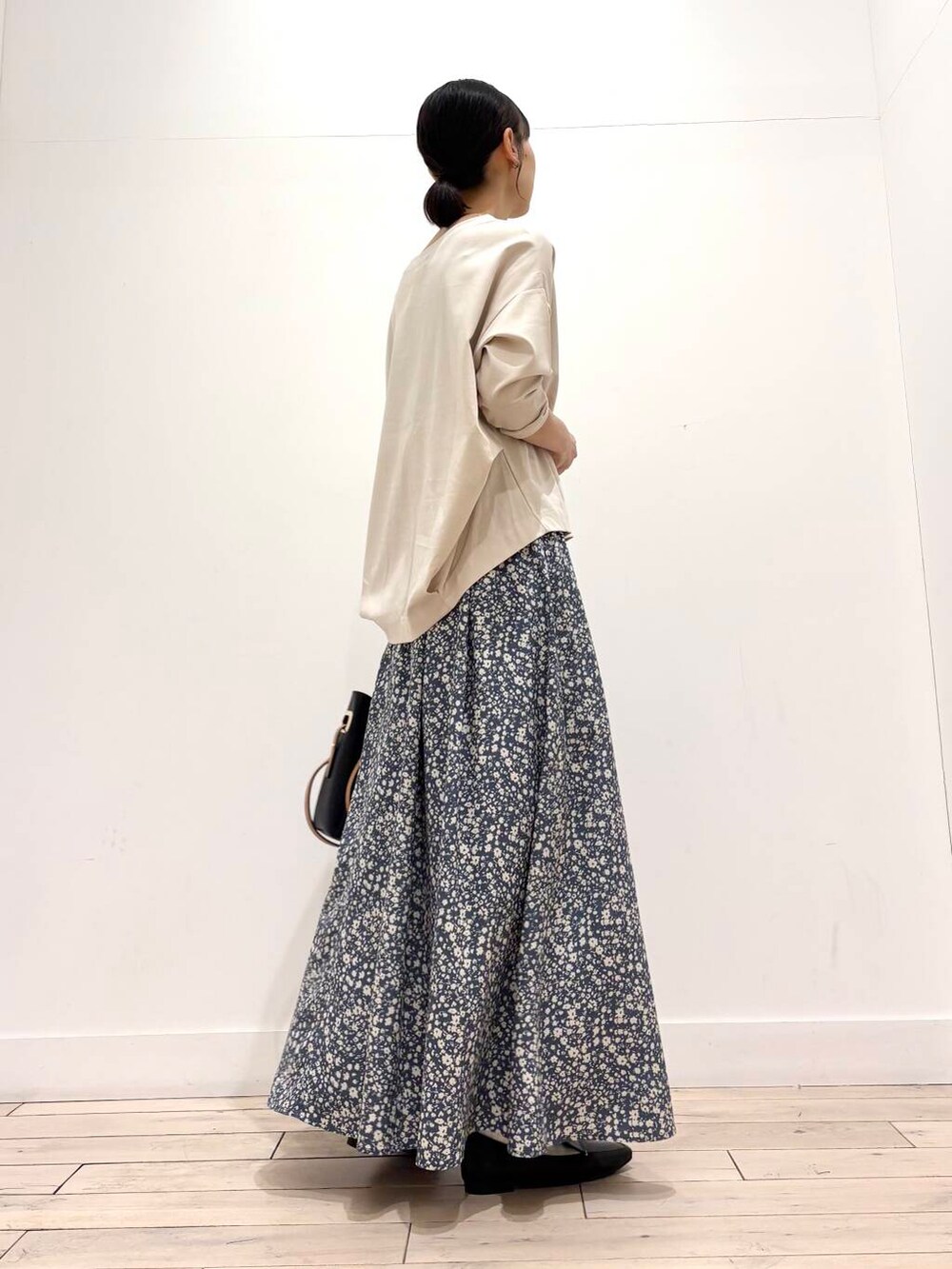 ブラック系のローファー、ブラック系のトートバッグ、ホワイト系のノーカラージャケットを着用したレディースの春コーディネートの7枚目の写真