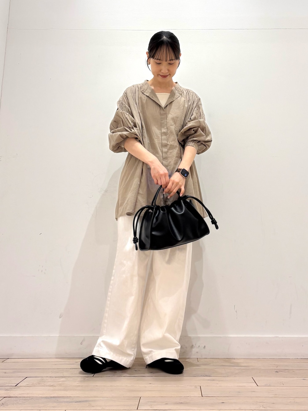 ホワイト系のタンクトップ、ベージュ系のシャツ/ブラウス、ブラック系のトートバッグを着用したレディースの春コーディネートの2枚目の写真