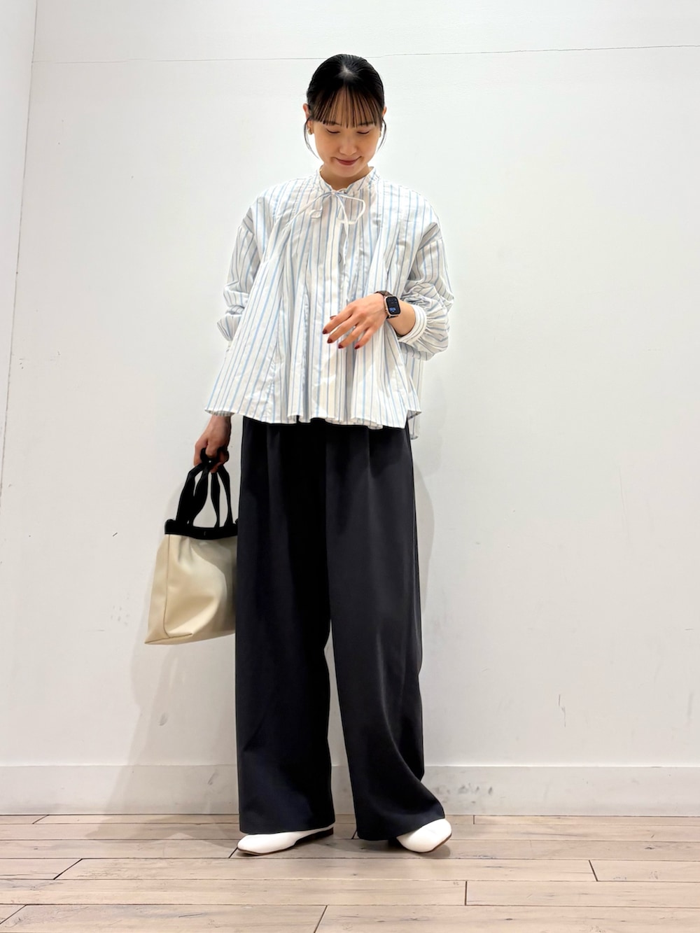 ホワイト系のシャツ/ブラウス、ホワイト系のその他シューズ、ホワイト系のハンドバッグを着用したレディースの春コーディネートの2枚目の写真