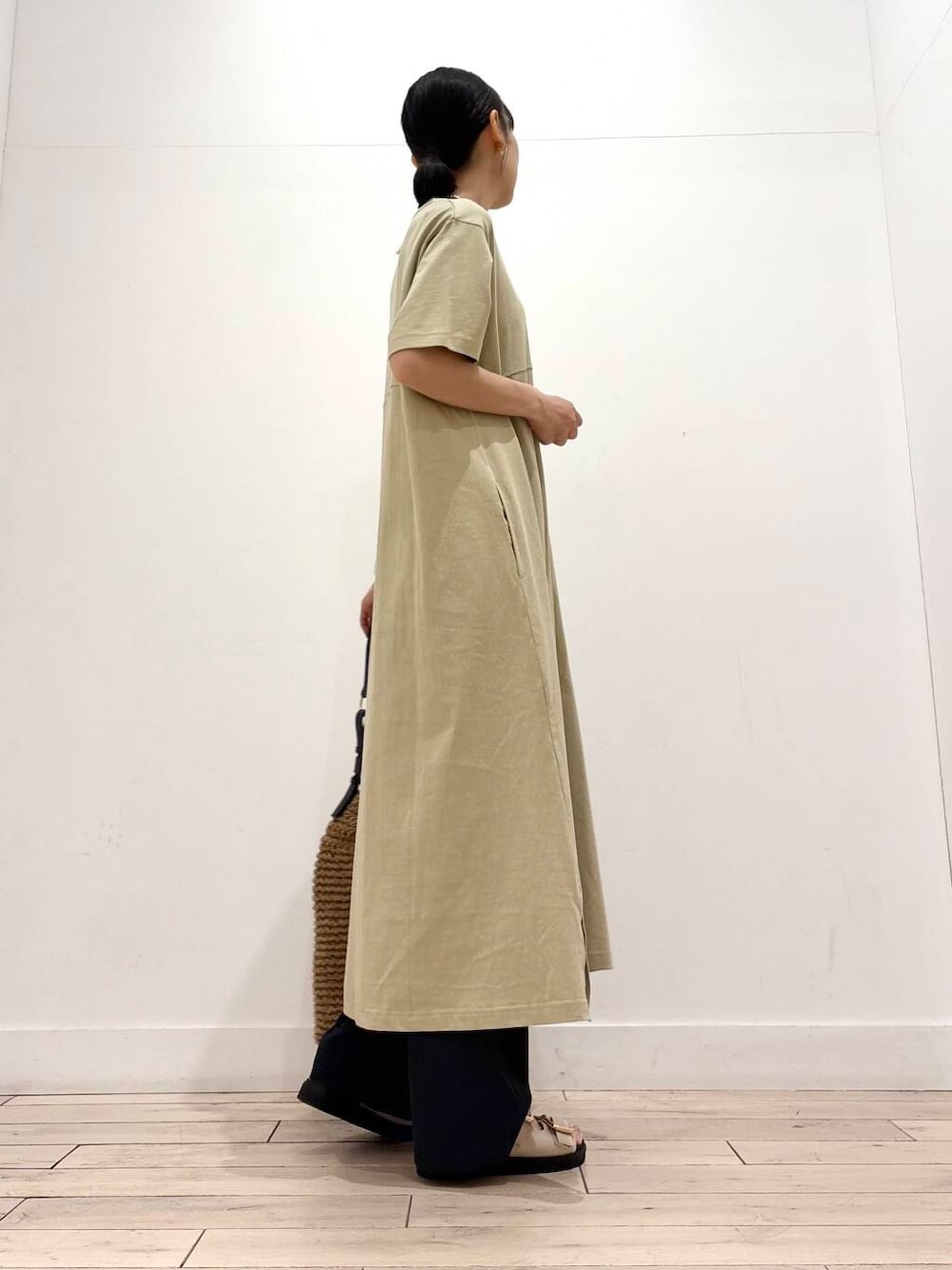 イエロー系のトートバッグ、ホワイト系のサンダル、グレー系のその他パンツを着用したレディースの春コーディネートの4枚目の写真