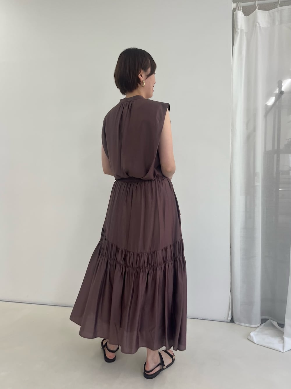ブラウン系のスカート、ブラウン系のシャツ/ブラウスを着用したレディースの夏コーディネートの3枚目の写真