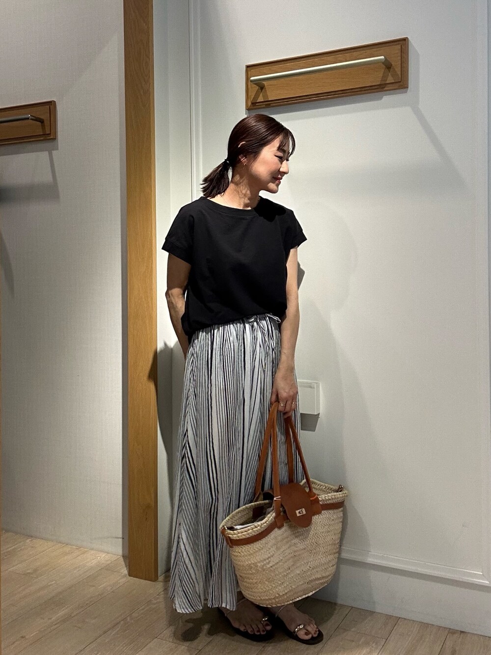 ブラック系のTシャツ/カットソー、グレー系のスカートを着用したレディースの夏コーディネートの5枚目の写真