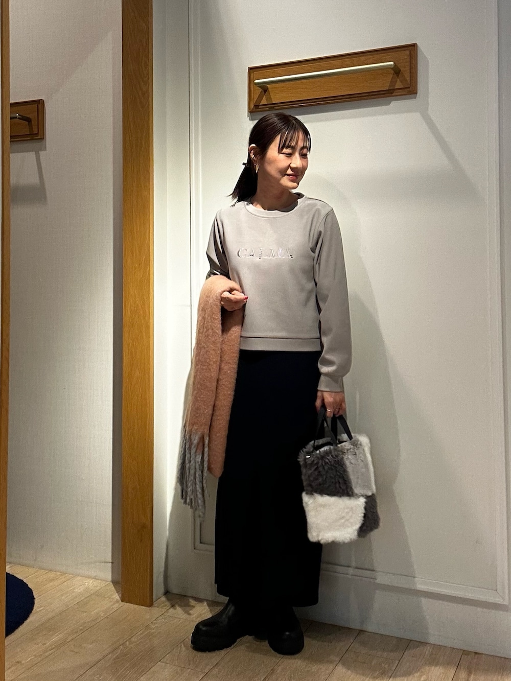 ホワイト系のダウンジャケット/コート、ピンク系のニット/セーター、グレー系のTシャツ/カットソーを着用したレディースの冬コーディネートの8枚目の写真