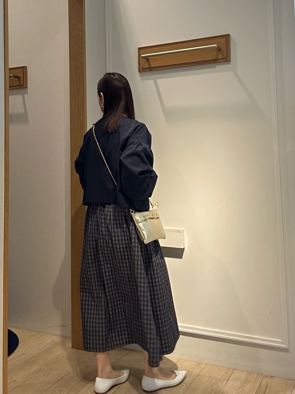 ブルー系のノーカラージャケット、ホワイト系のTシャツ/カットソー、ブラウン系のスカートを着用したレディースの冬コーディネートの4枚目の写真