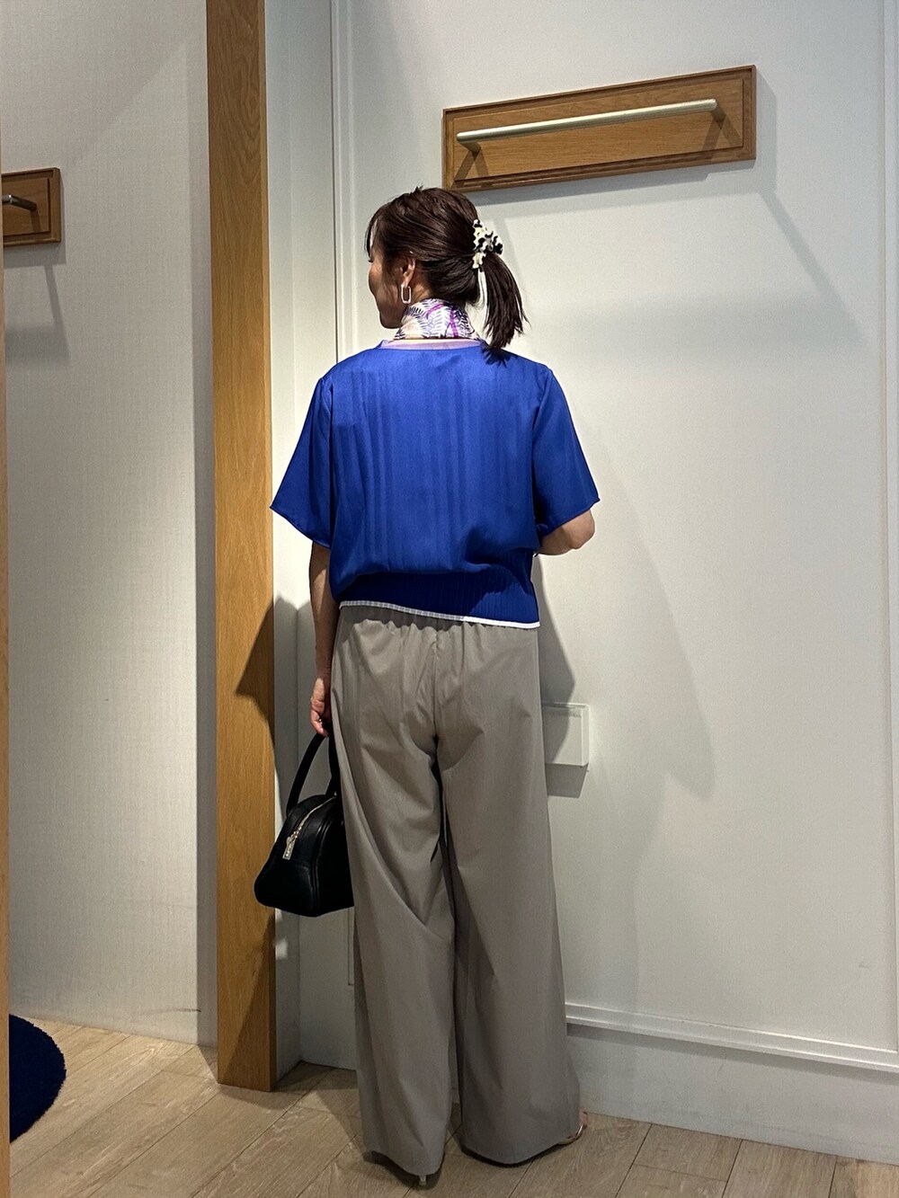 ブルー系のシャツ/ブラウス、ベージュ系のその他パンツ、ブラック系のボストンバッグを着用したレディースの夏コーディネートの6枚目の写真