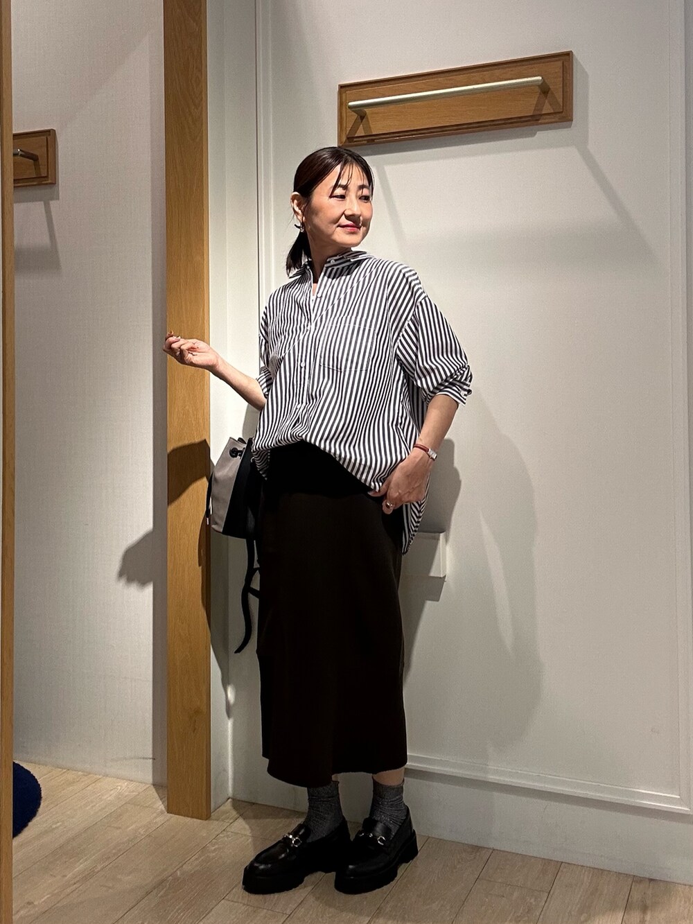 ブラック系のシャツ/ブラウス、ブラウン系のスカート、ブラック系のキャミソールを着用したレディースの秋コーディネートの7枚目の写真