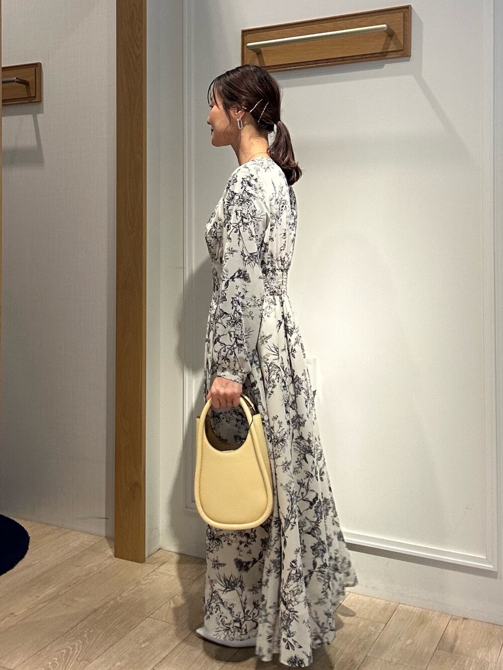 ベージュ系のワンピース、ブルー系のテーラードジャケットを着用したレディースの春コーディネートの3枚目の写真