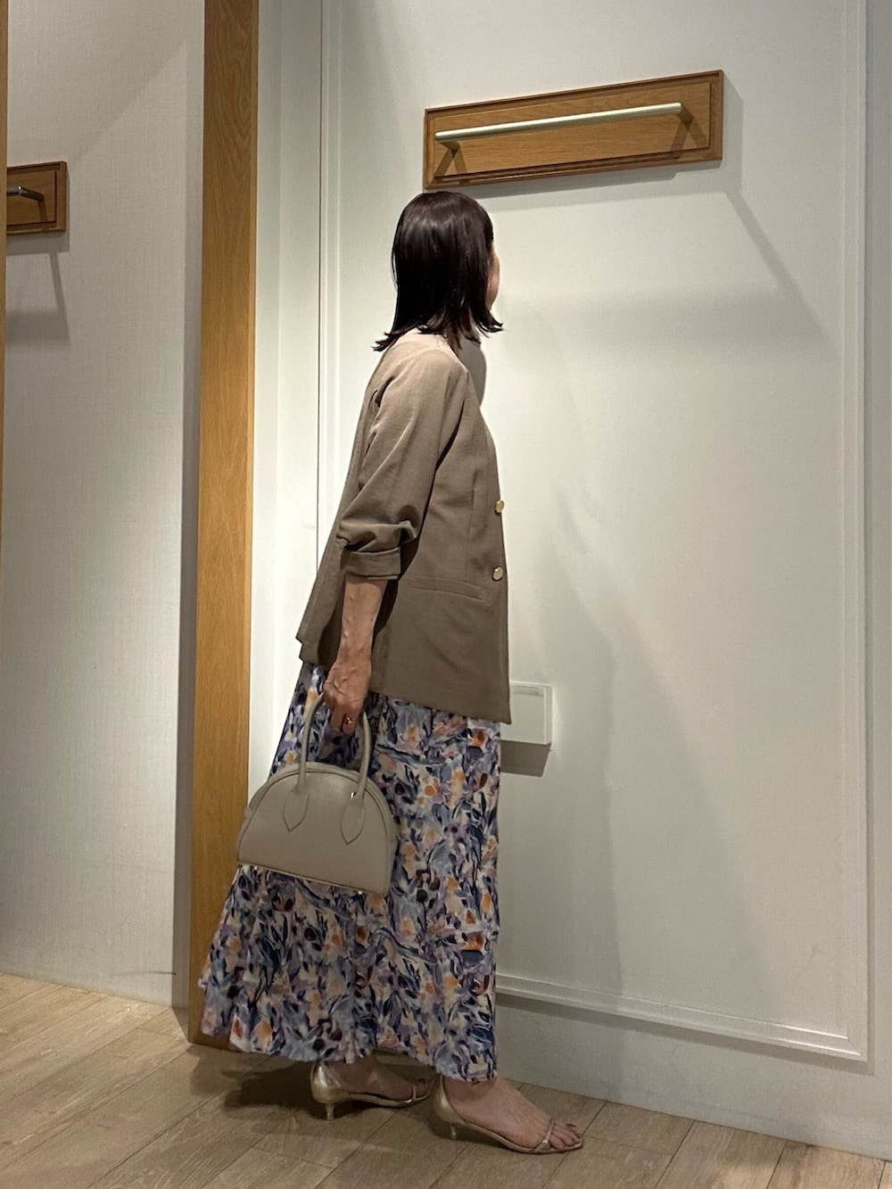 ブルー系のワンピース、イエロー系のノーカラージャケット、ベージュ系のボストンバッグを着用したレディースの夏コーディネートの4枚目の写真