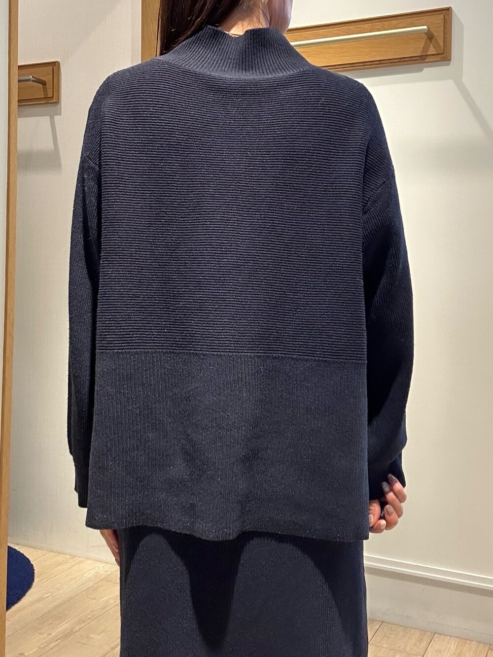 ホワイト系のトートバッグ、ブラウン系のローファー、ブルー系のニット/セーターを着用したレディースの冬コーディネートの10枚目の写真