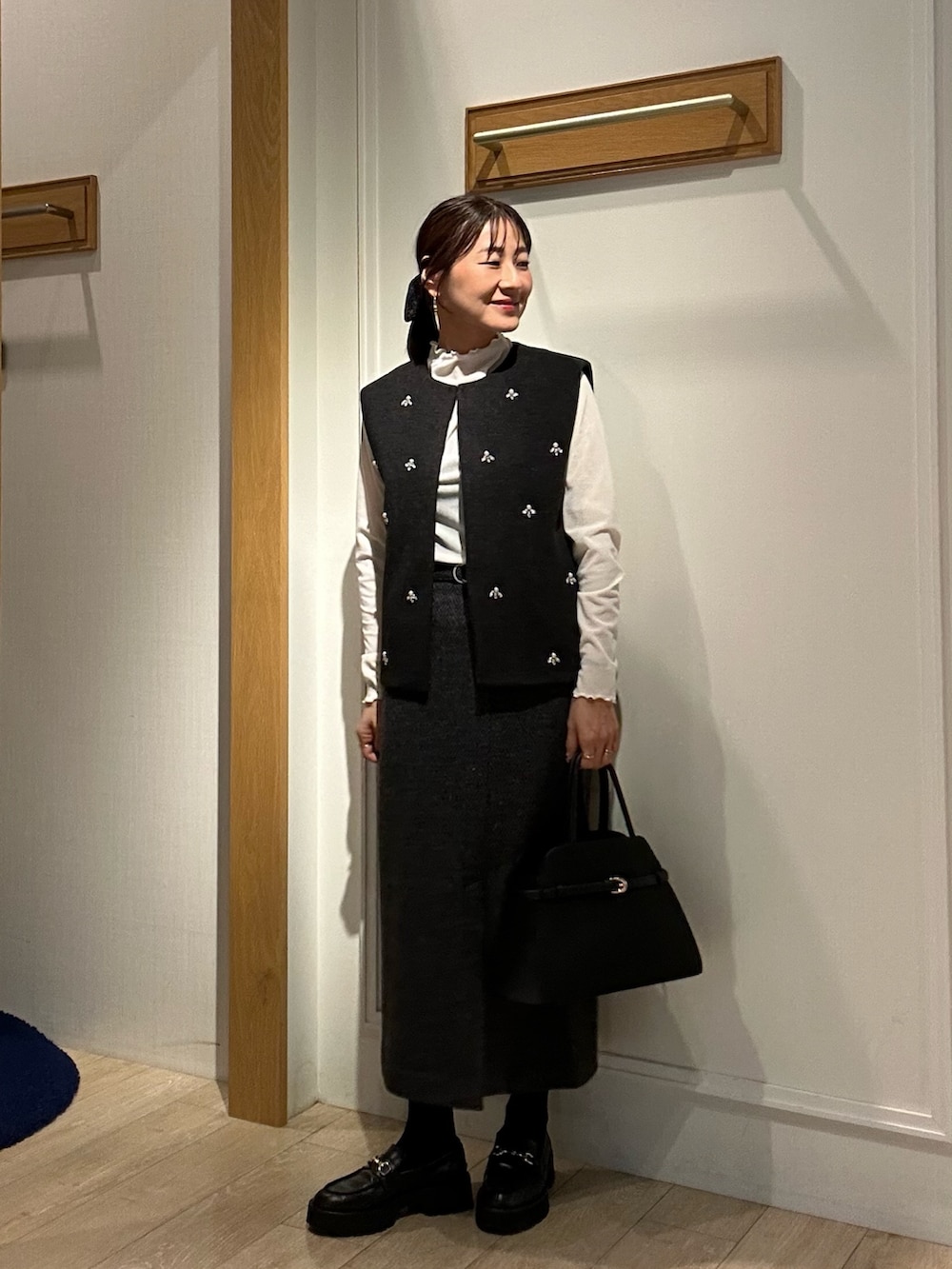 グレー系のブルゾン、ホワイト系のTシャツ/カットソー、グレー系のスカートを着用したレディースの秋コーディネートの5枚目の写真