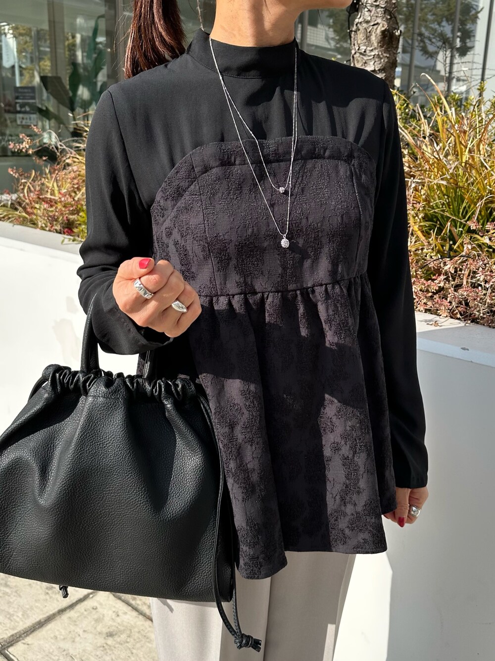 ブラック系のシャツ/ブラウス、ベージュ系のその他パンツ、ブラック系のショルダーバッグを着用したレディースの冬コーディネートの5枚目の写真