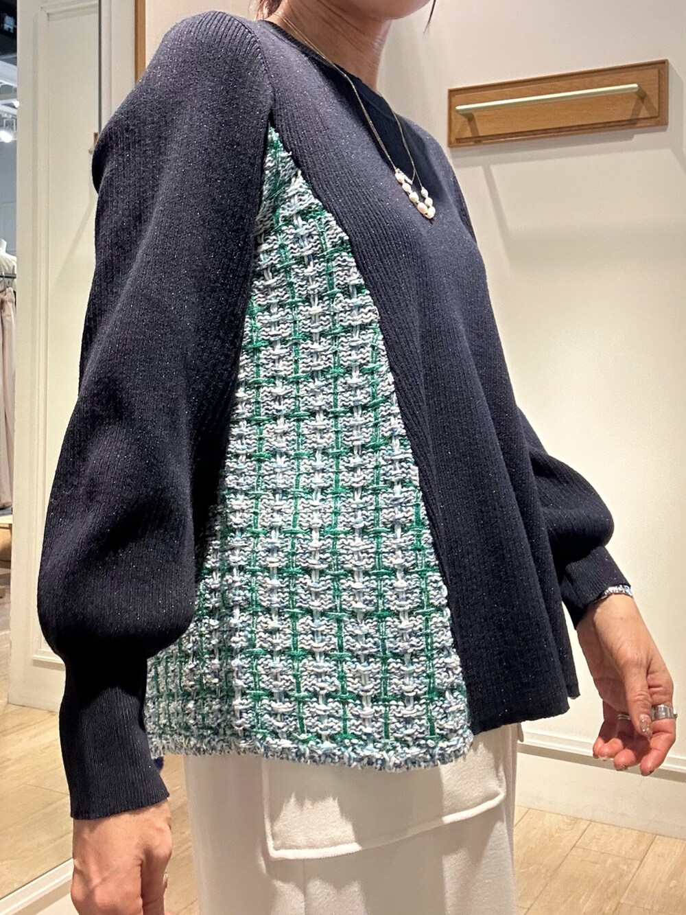 ブルー系のニット/セーター、ブルー系のスカート、グリーン系のショルダーバッグを着用したレディースの冬コーディネートの5枚目の写真