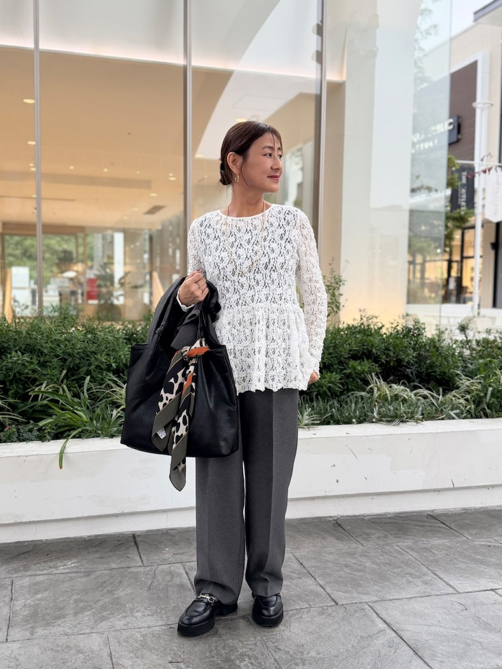 ブラック系のその他パンツ、ブラック系のトートバッグ、グレー系のTシャツ/カットソーを着用したレディースの秋コーディネートの8枚目の写真