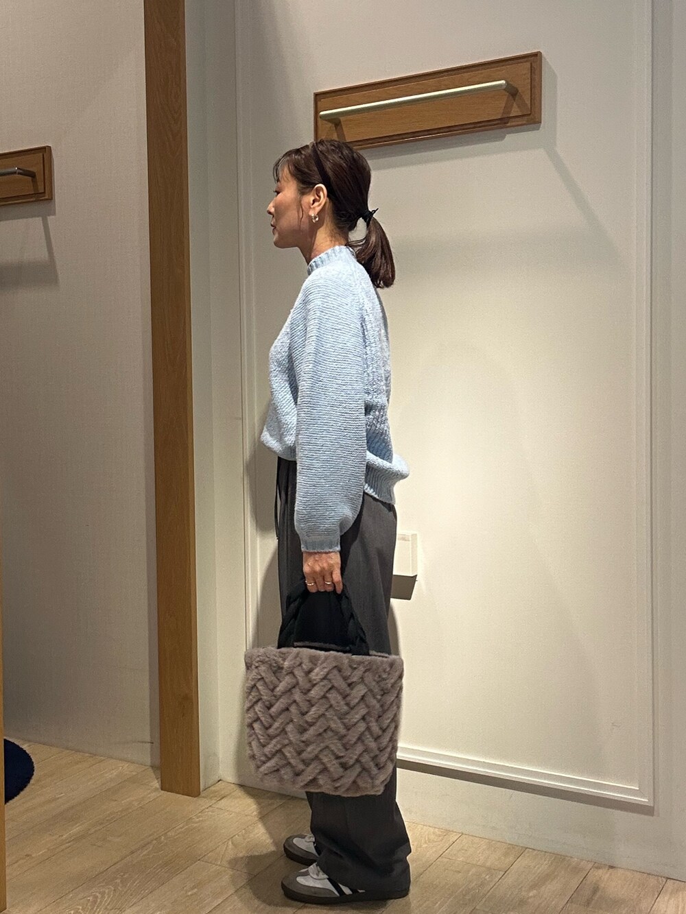 ブルー系のニット/セーターを着用したレディースの冬コーディネートの3枚目の写真