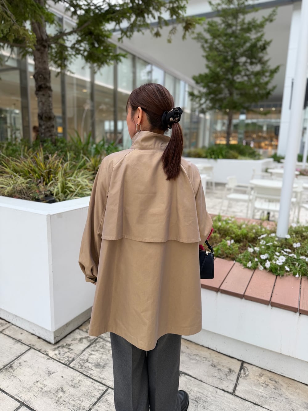 イエロー系のダッフルコート、ブラック系のその他パンツ、ホワイト系のシャツ/ブラウスを着用したレディースの秋コーディネートの6枚目の写真