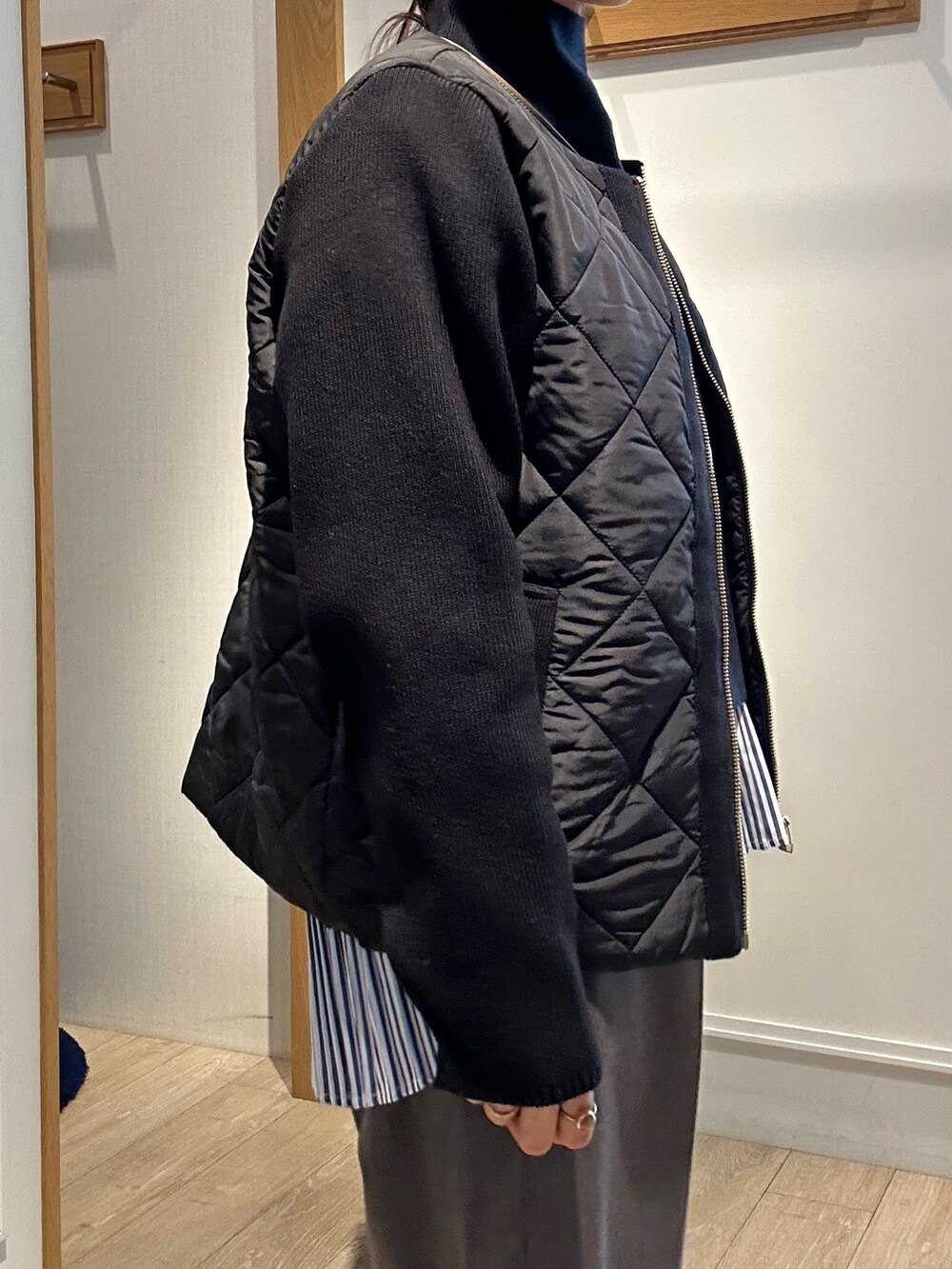 ブラック系のブルゾン、ブラック系のニット/セーター、グレー系のその他パンツを着用したレディースの秋コーディネートの6枚目の写真