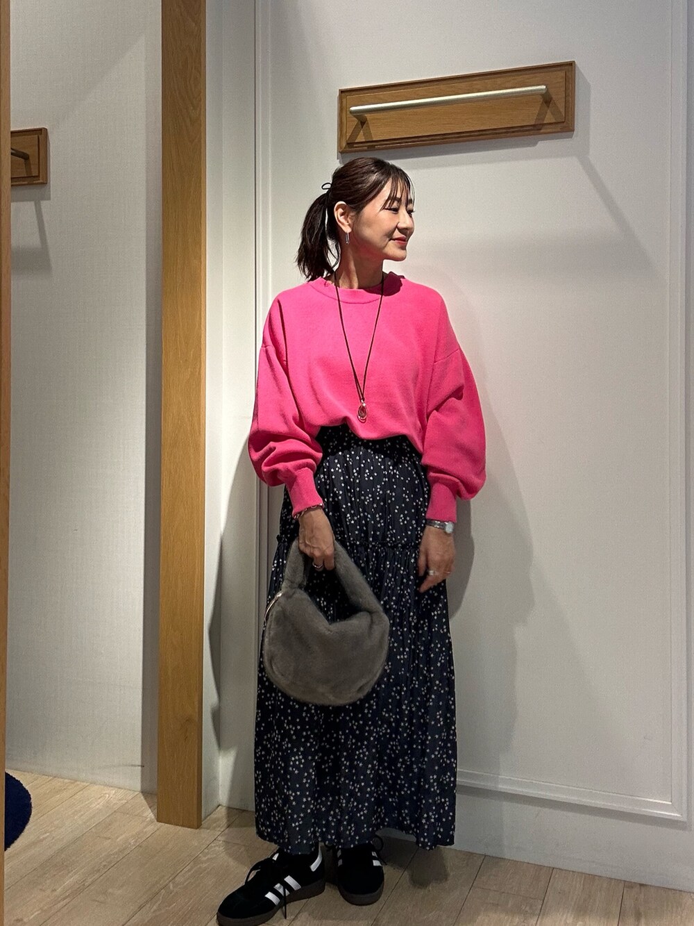 グレー系のトレンチコート、ピンク系のニット/セーターを着用したレディースの秋コーディネートの10枚目の写真
