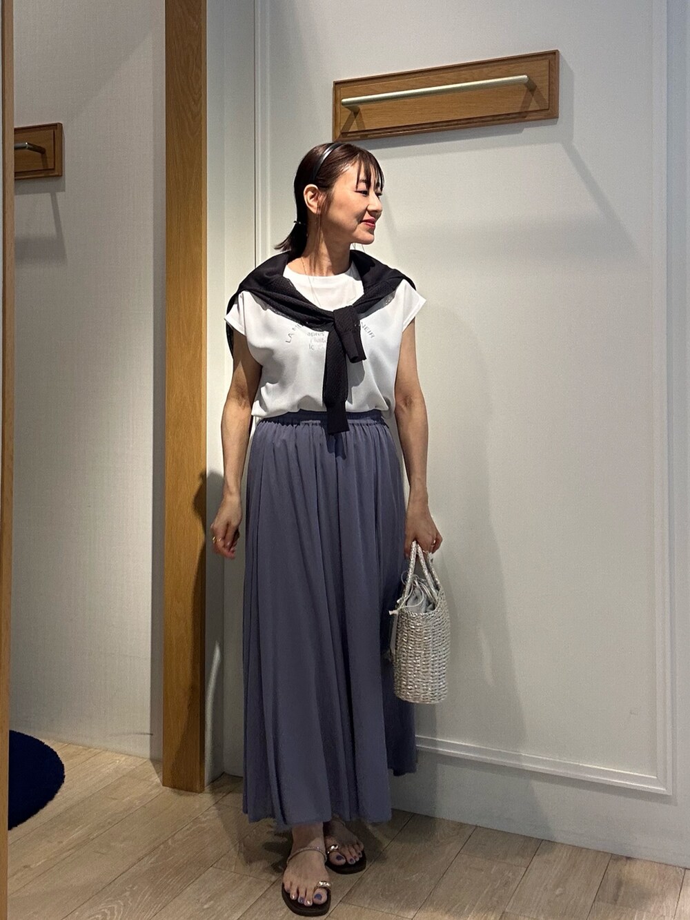 パープル系のスカート、ホワイト系のシャツ/ブラウス、グレー系のカーディガン/ボレロを着用したレディースの夏コーディネートの5枚目の写真