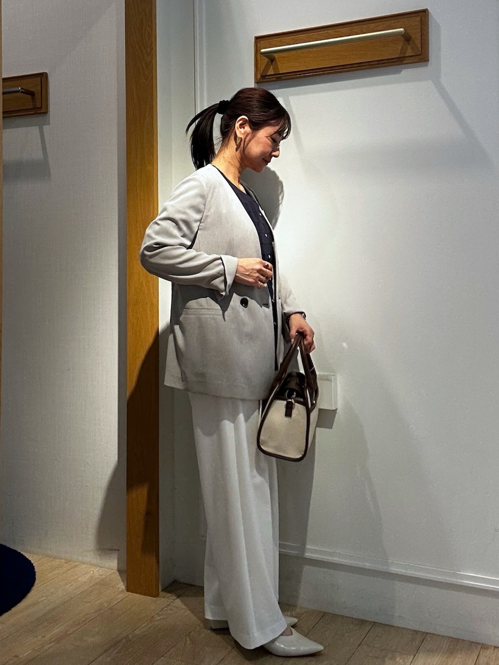 ブルー系のシャツ/ブラウス、ベージュ系のノーカラージャケット、ホワイト系のTシャツ/カットソーを着用したレディースの春コーディネートの2枚目の写真