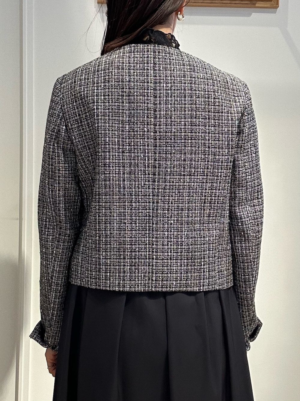 ブラック系のノーカラージャケット、ブラック系のTシャツ/カットソー、ブルー系のスカートを着用したレディースの冬コーディネートの7枚目の写真