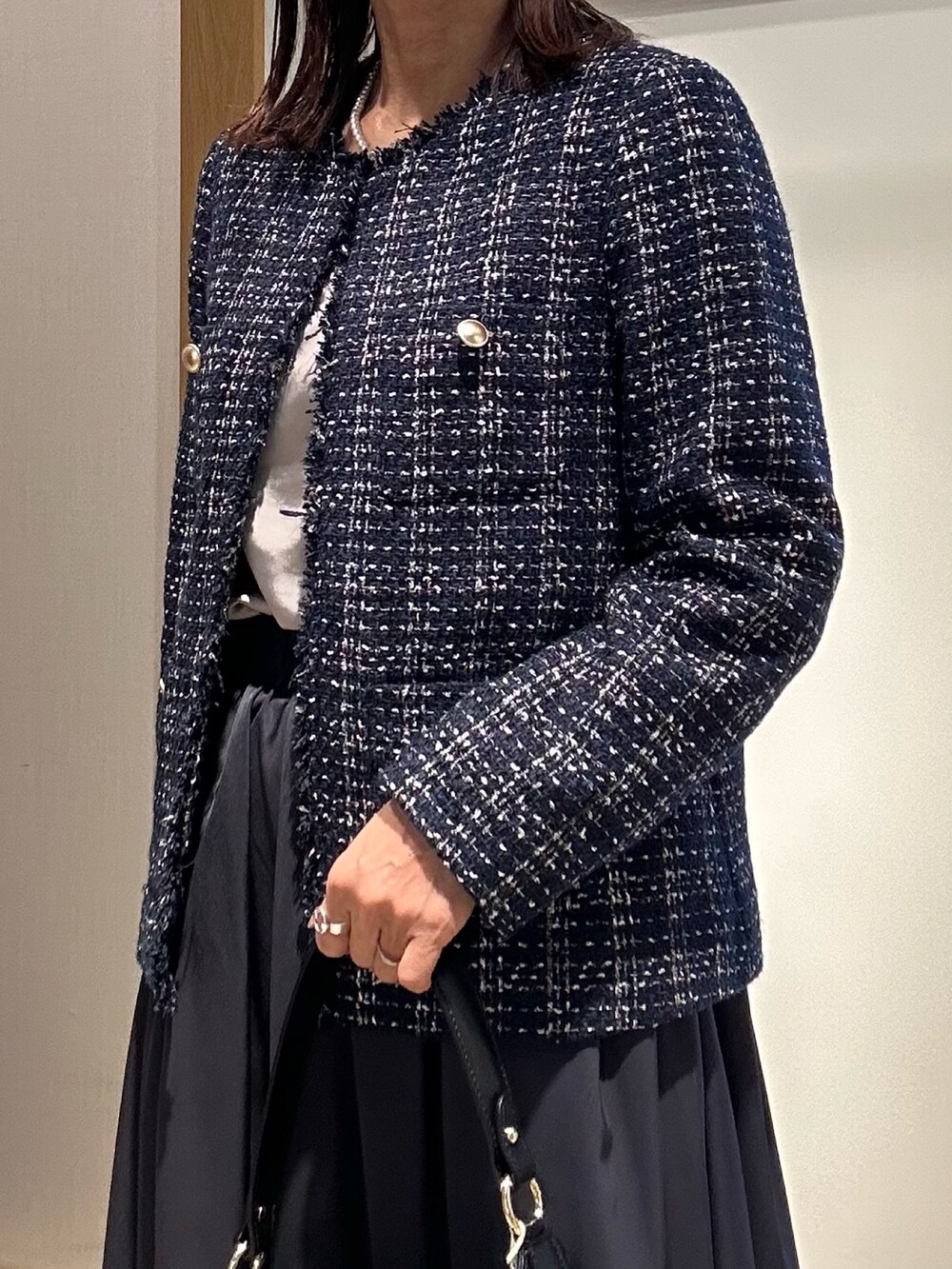 ブルー系のノーカラージャケット、ブルー系のスカートを着用したレディースの冬コーディネートの6枚目の写真