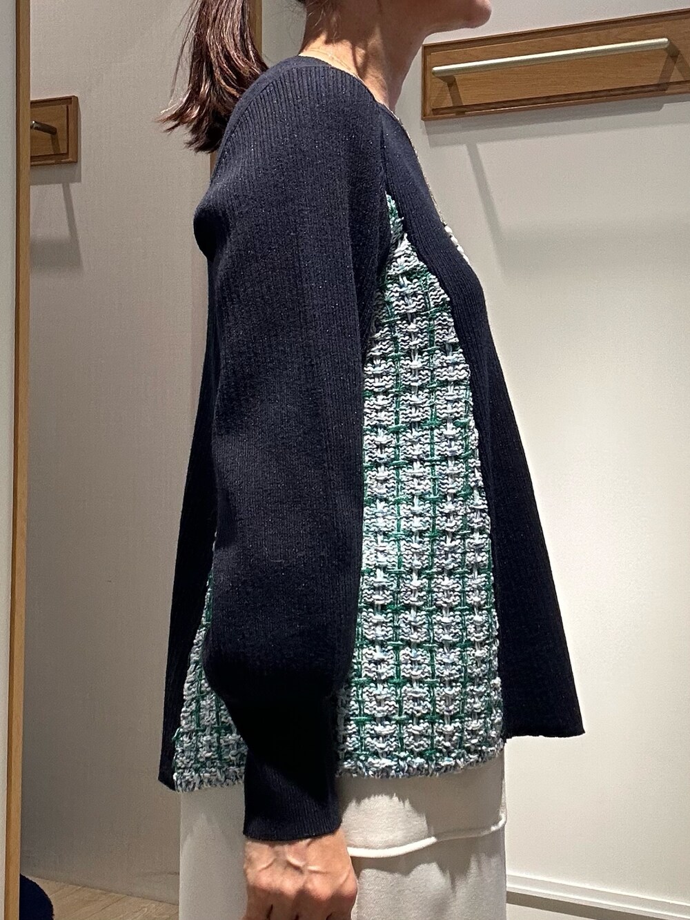 ブルー系のニット/セーター、ブルー系のスカート、グリーン系のショルダーバッグを着用したレディースの冬コーディネートの6枚目の写真