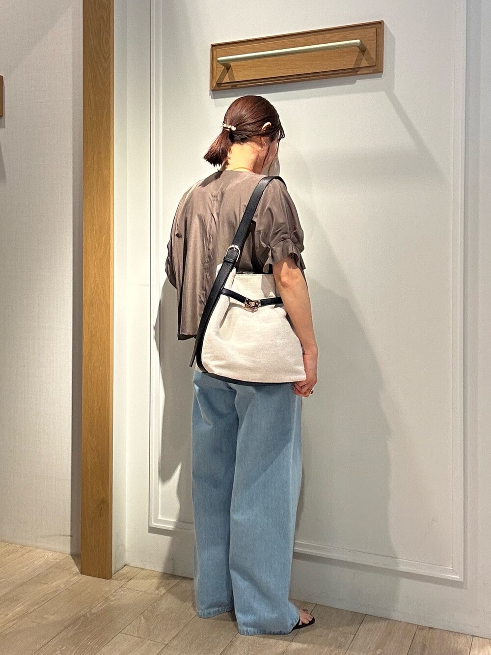 グリーン系のノーカラージャケット、ブルー系のデニムパンツ、ブラック系のサンダルを着用したレディースの夏コーディネートの3枚目の写真