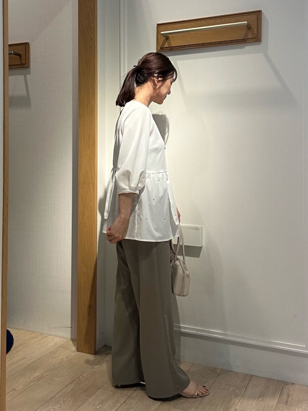 ホワイト系のシャツ/ブラウス、グリーン系のその他パンツ、ホワイト系のボストンバッグを着用したレディースの春コーディネートの3枚目の写真