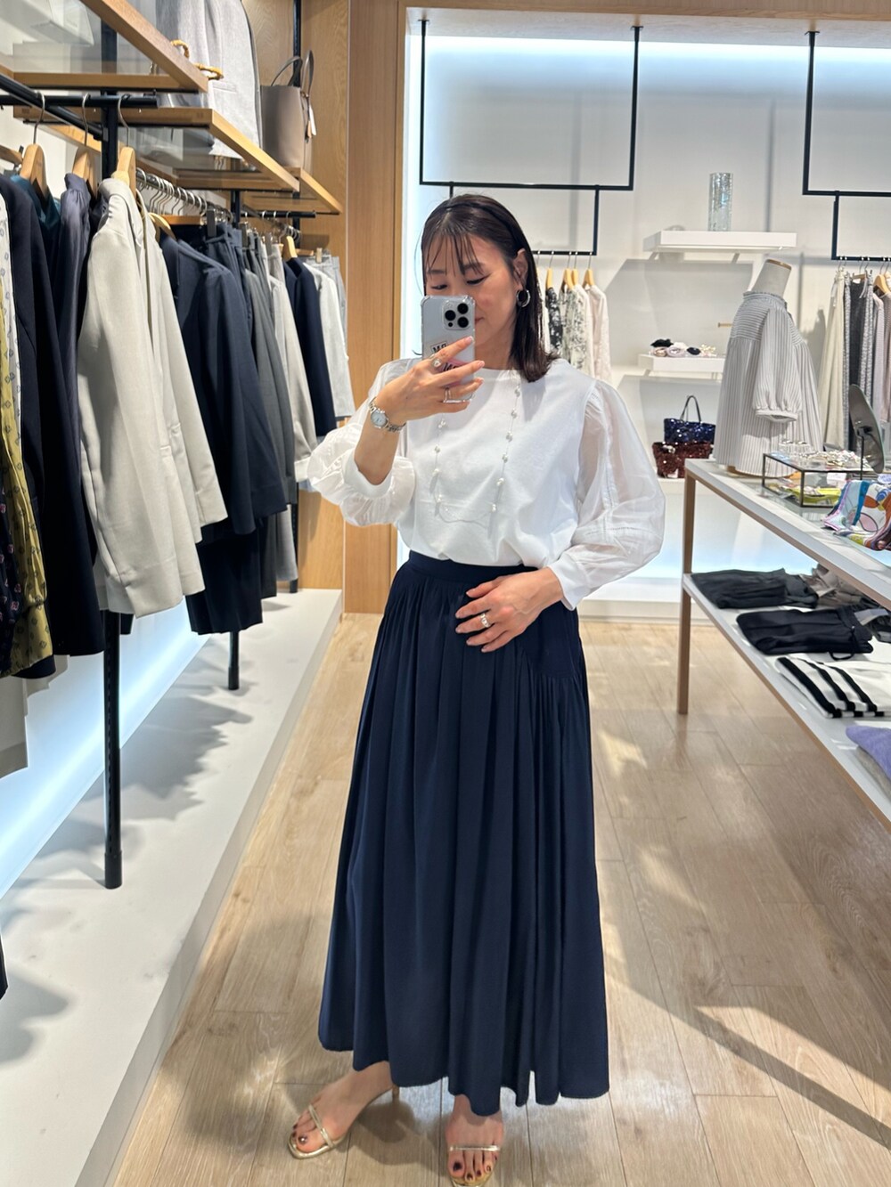 ホワイト系のTシャツ/カットソー、ベージュ系のスカートを着用したレディースの春コーディネートの9枚目の写真