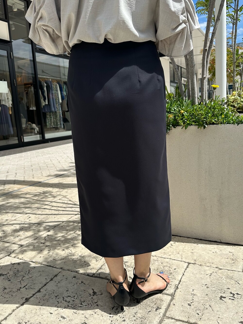 ブラック系のサンダル、ベージュ系のシャツ/ブラウス、ブルー系のスカートを着用したレディースの夏コーディネートの9枚目の写真