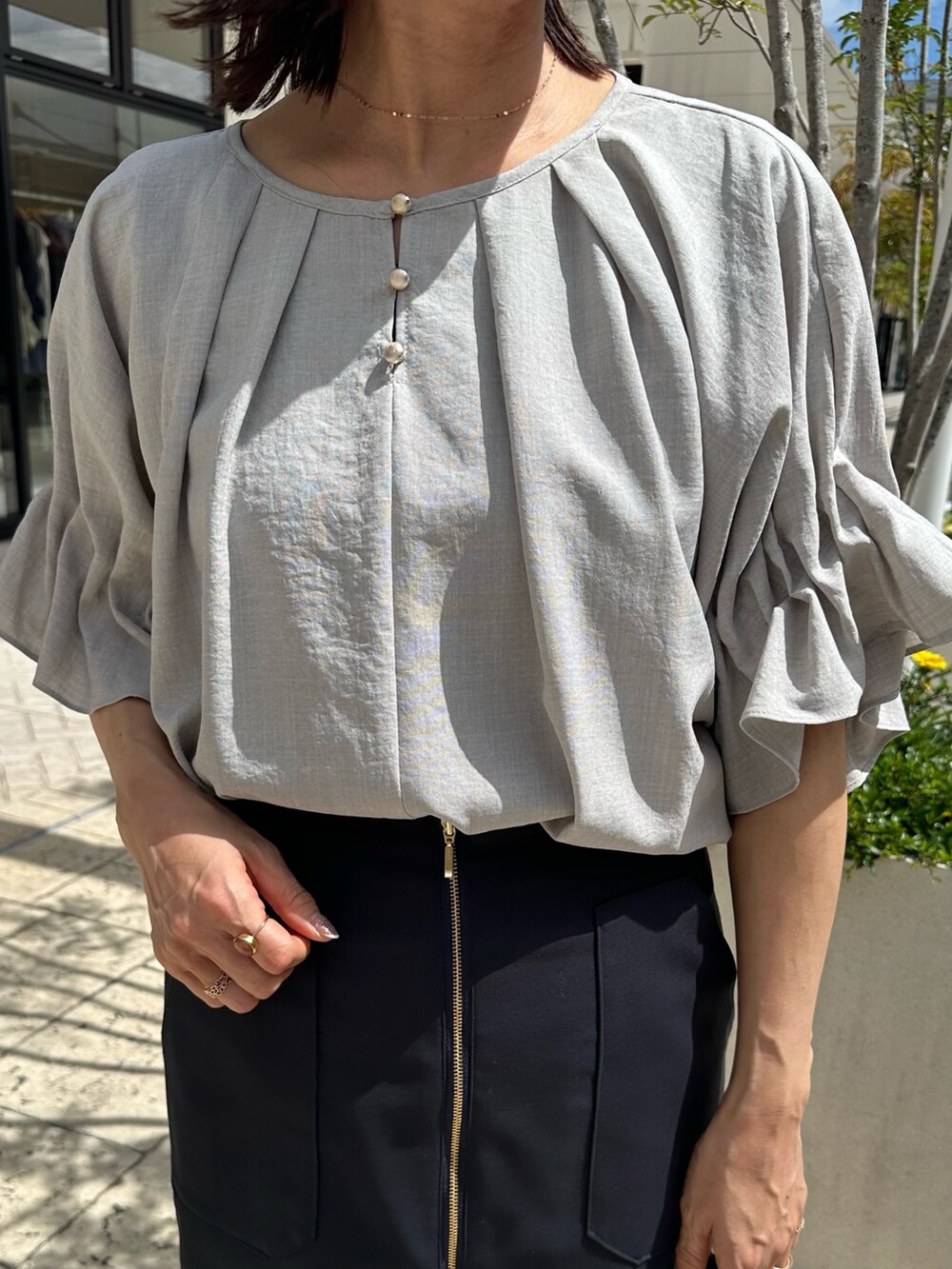 ブラック系のサンダル、ベージュ系のシャツ/ブラウス、ブルー系のスカートを着用したレディースの夏コーディネートの4枚目の写真