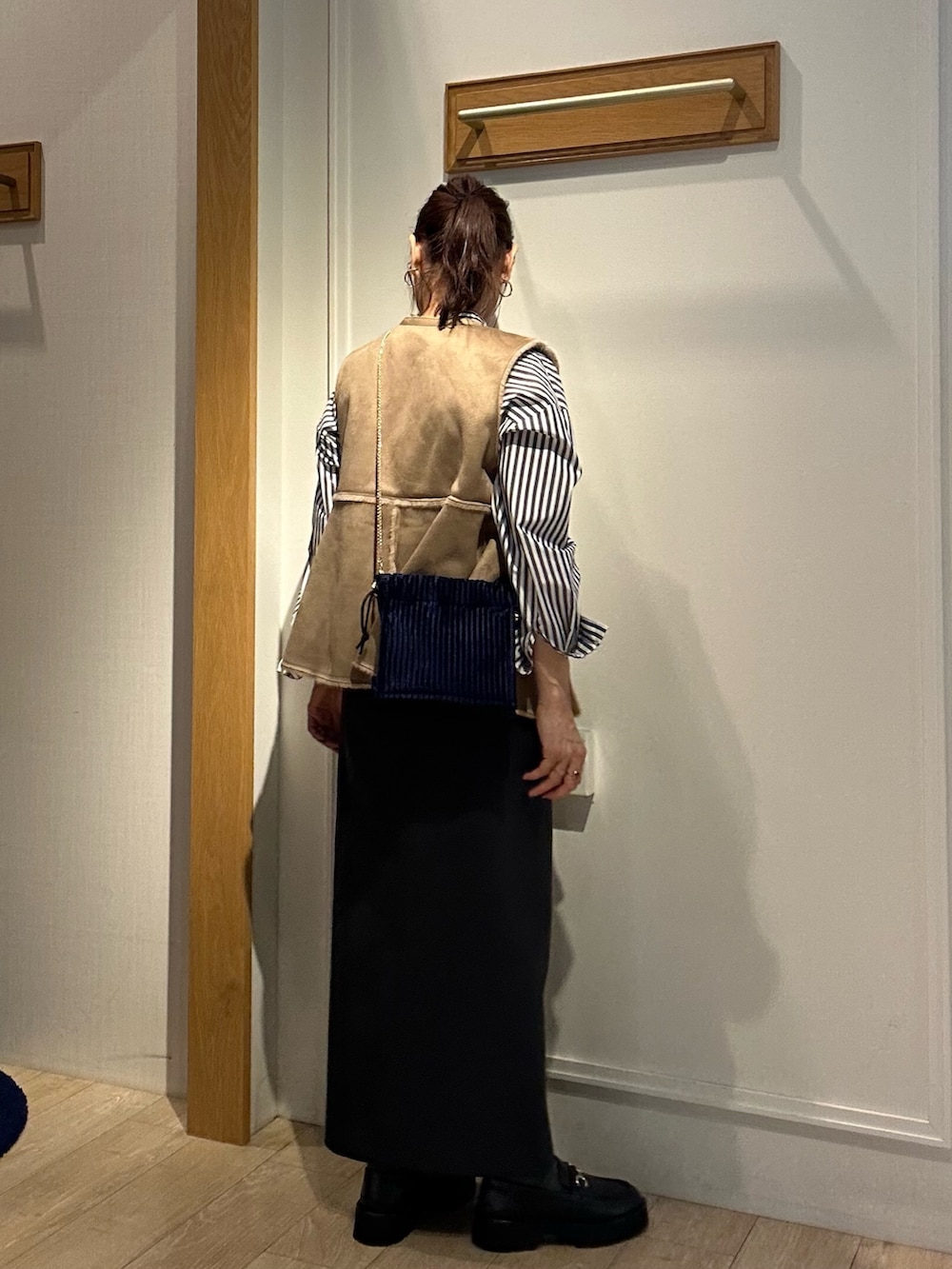 グレー系のスカート、ブラック系のシャツ/ブラウス、イエロー系のブルゾンを着用したレディースの秋コーディネートの6枚目の写真
