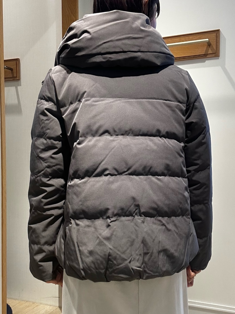 グレー系のダウンジャケット/コート、ピンク系のニット/セーター、ホワイト系のスカートを着用したレディースの冬コーディネートの7枚目の写真