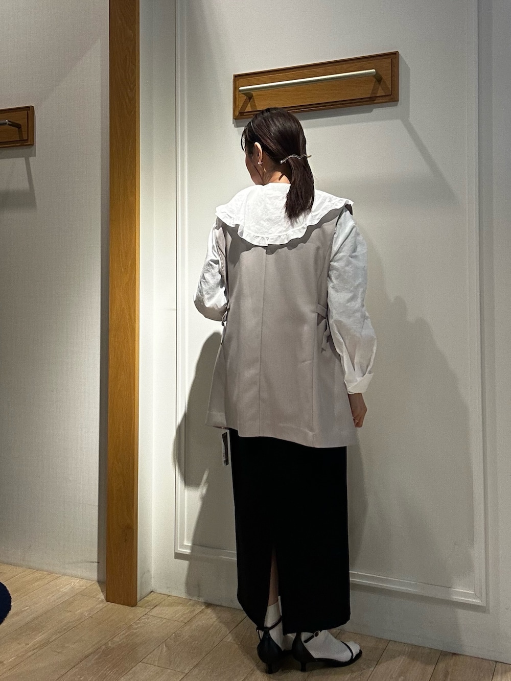 ベージュ系のダウンジャケット/コート、ホワイト系のシャツ/ブラウス、ブラック系のスカートを着用したレディースの春コーディネートの3枚目の写真