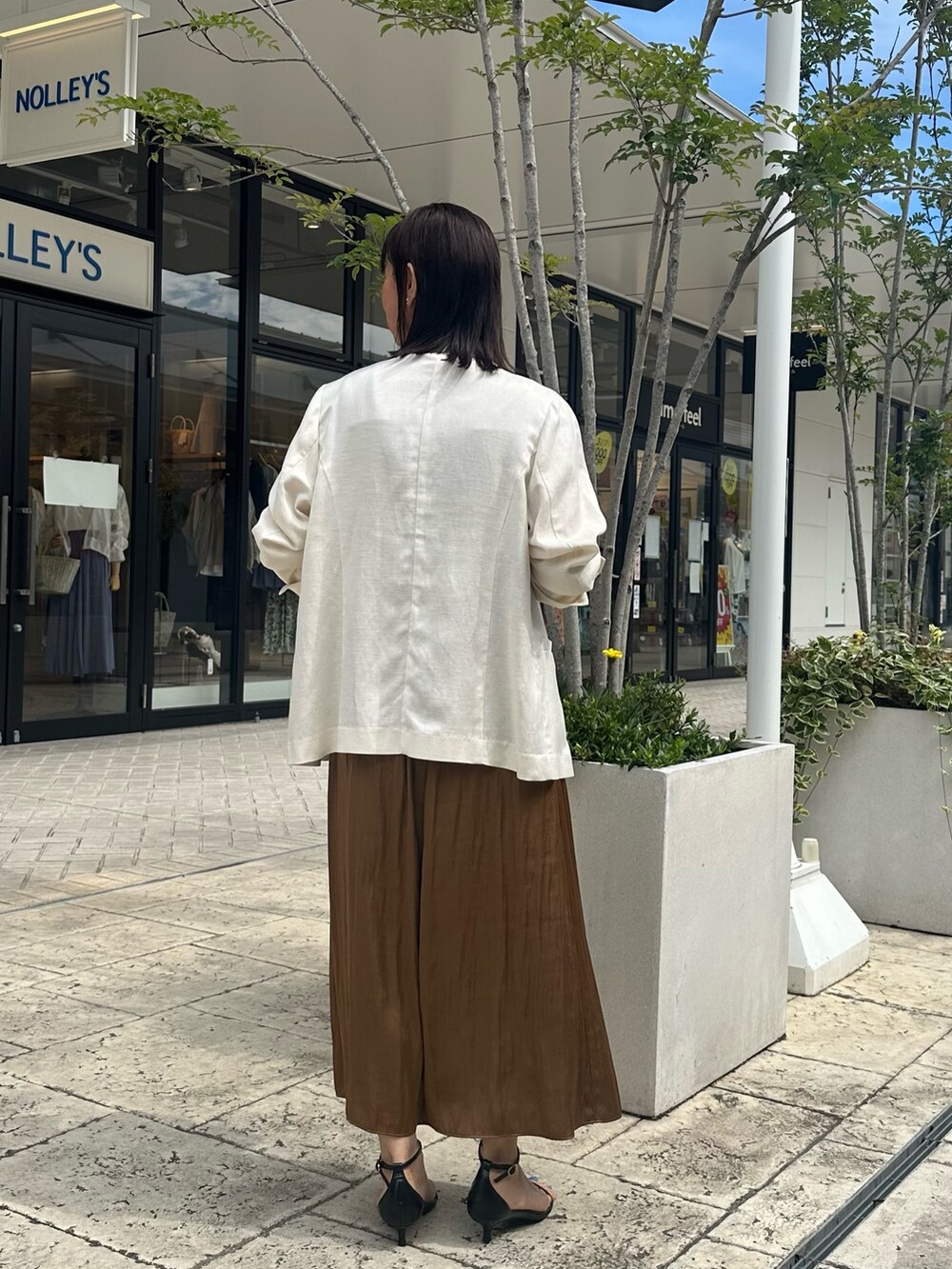 ブラウン系のワンピース、グレー系のTシャツ/カットソー、ホワイト系のテーラードジャケットを着用したレディースの夏コーディネートの5枚目の写真