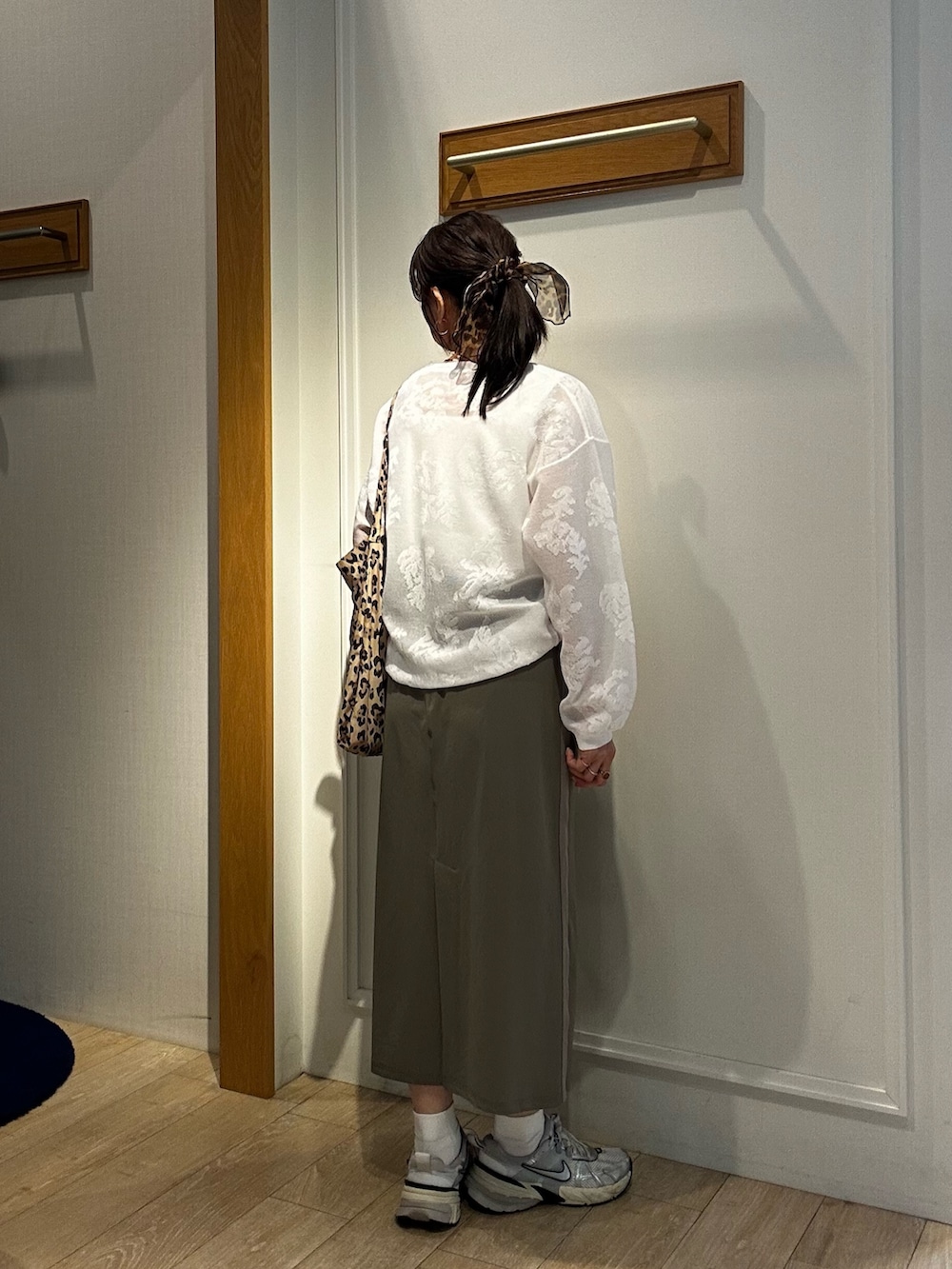 ホワイト系のニット/セーター、ホワイト系のTシャツ/カットソー、グリーン系のスカートを着用したレディースの春コーディネートの3枚目の写真