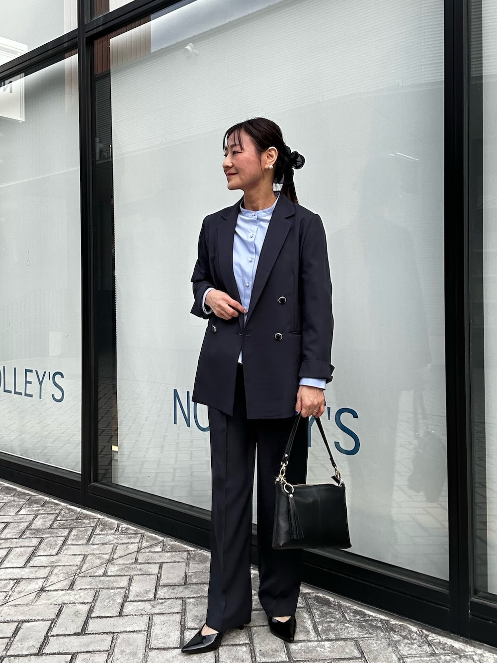 ホワイト系のショルダーバッグ、ベージュ系のブルゾン、ブルー系のテーラードジャケットを着用したレディースの春コーディネートの8枚目の写真