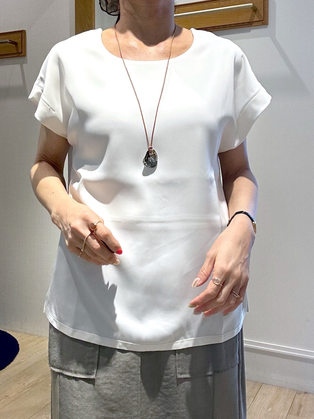 ホワイト系のTシャツ/カットソー、グリーン系のスカート、ブラック系のブルゾンを着用したレディースの春コーディネートの8枚目の写真