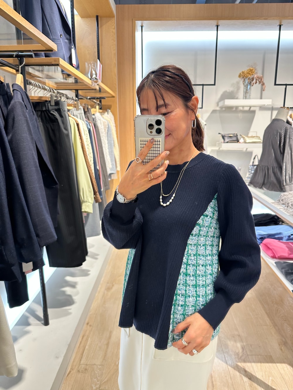 ブルー系のニット/セーター、ブルー系のスカート、グリーン系のショルダーバッグを着用したレディースの冬コーディネートの7枚目の写真