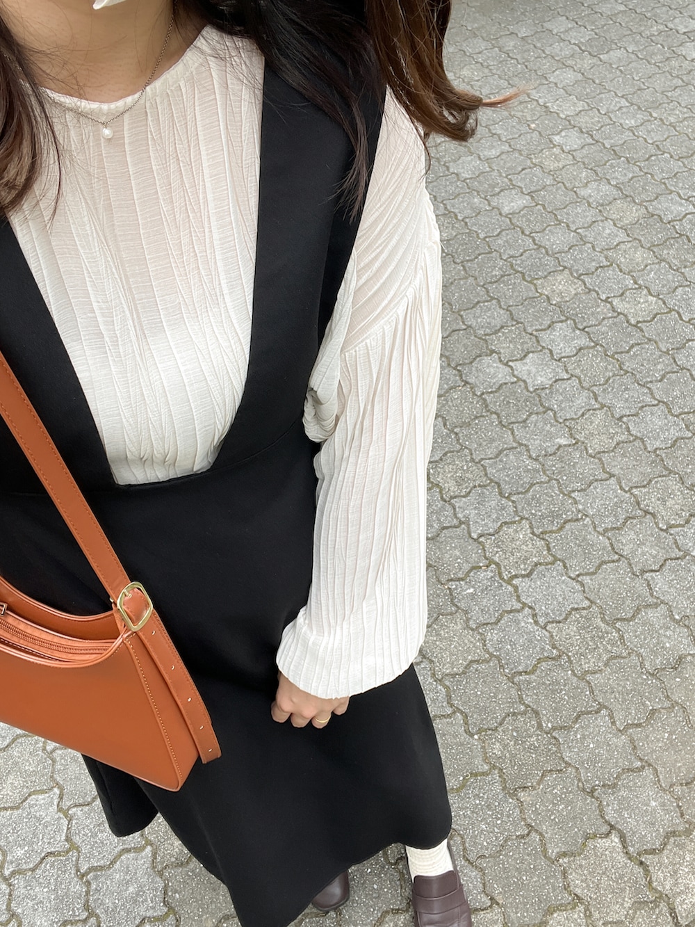 ホワイト系のシャツ/ブラウス、ブラック系のサロペット/オーバーオール、ブラウン系のローファーを着用したレディースの秋コーディネートの2枚目の写真