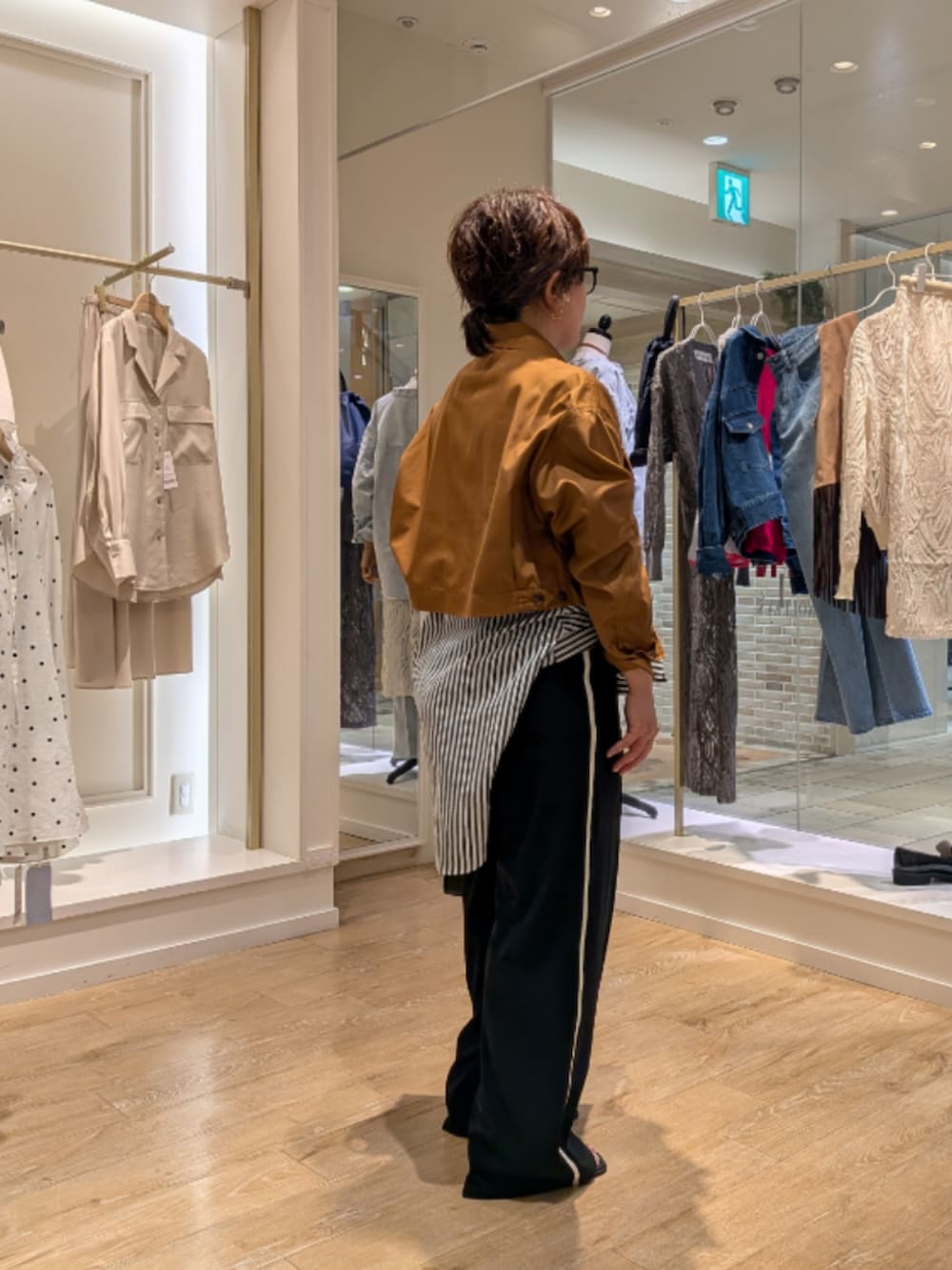 イエロー系のブルゾン、ブルー系のシャツ/ブラウス、ブラック系のその他パンツを着用したレディースの秋コーディネートの3枚目の写真