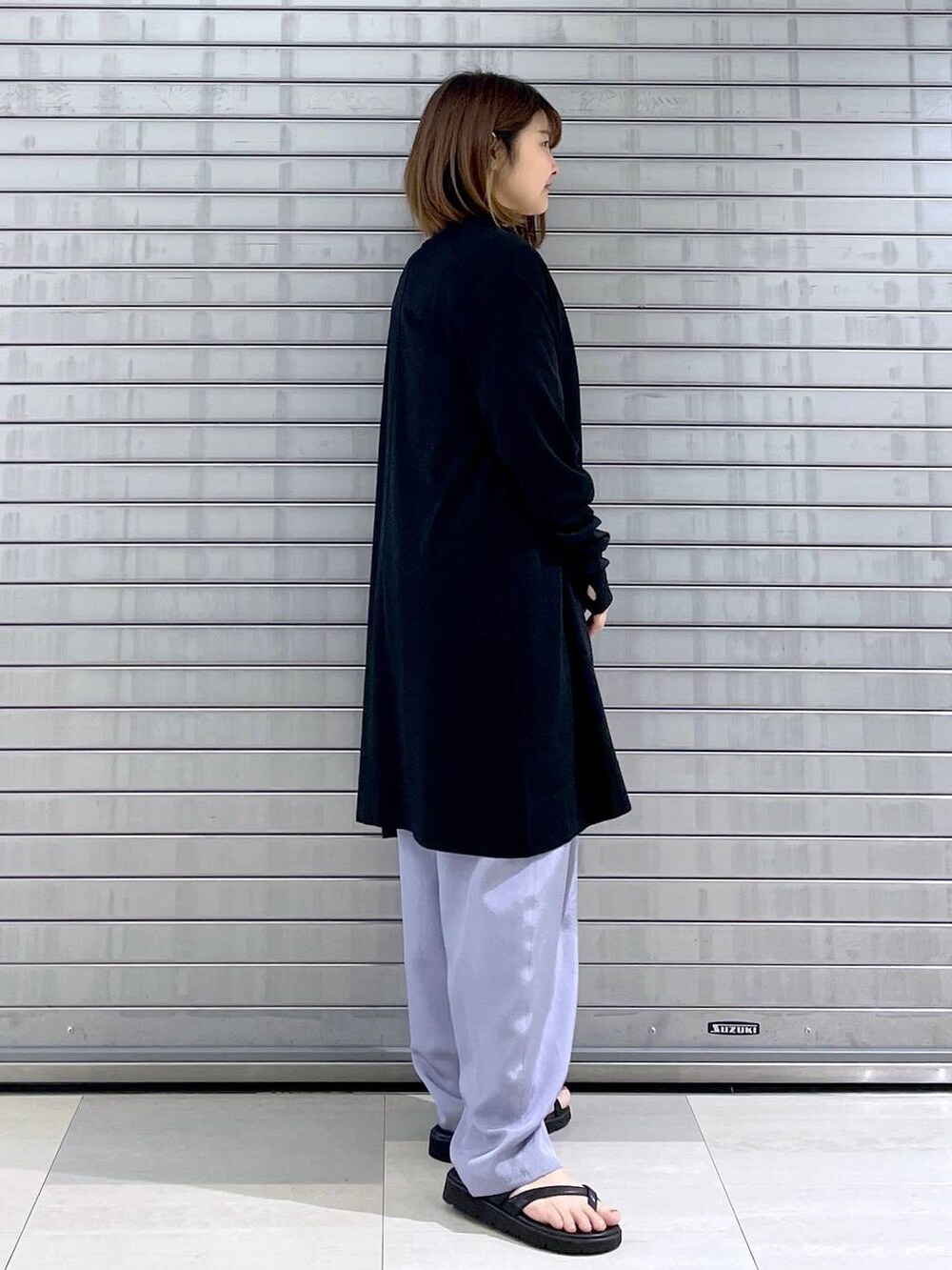 ブラック系のカーディガン/ボレロ、ブラック系のバックパック/リュック、ブラック系のシャツ/ブラウスを着用したレディースの春コーディネートの5枚目の写真