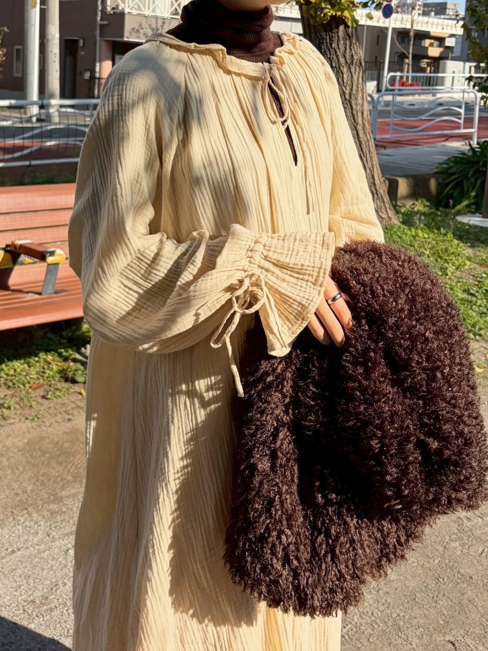 ベージュ系のワンピースを着用したレディースの春コーディネートの4枚目の写真