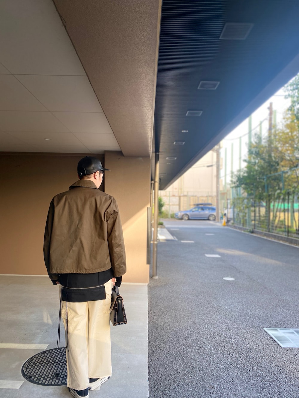 ホワイト系のシャツ/ブラウス、ブラック系のベスト、ブラウン系のミリタリージャケットを着用したメンズの冬コーディネートの2枚目の写真