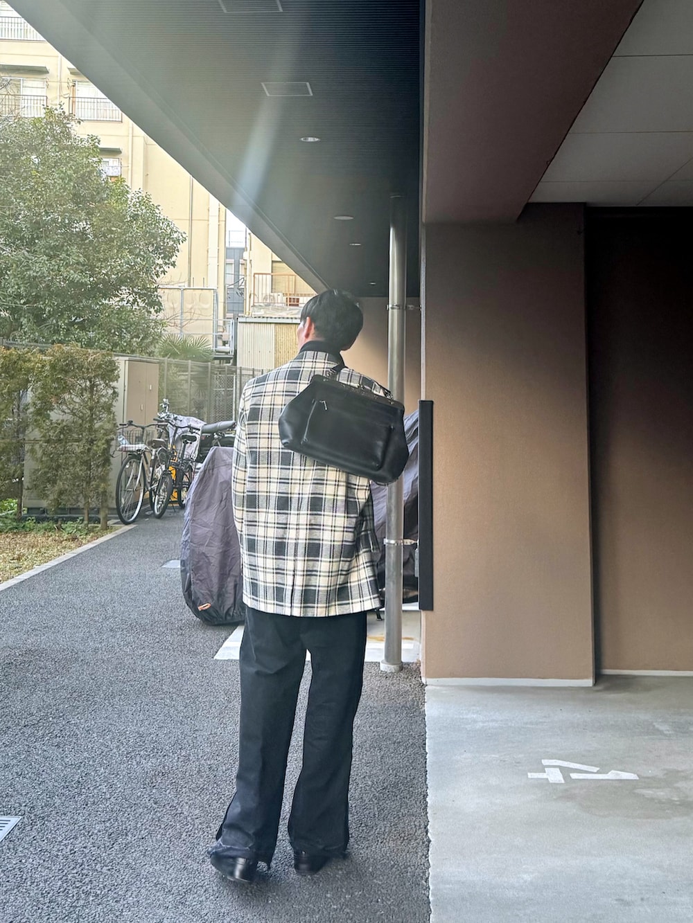 その他のテーラードジャケット、ホワイト系のニット/セーター、ブラック系のショルダーバッグを着用したメンズの冬コーディネートの3枚目の写真