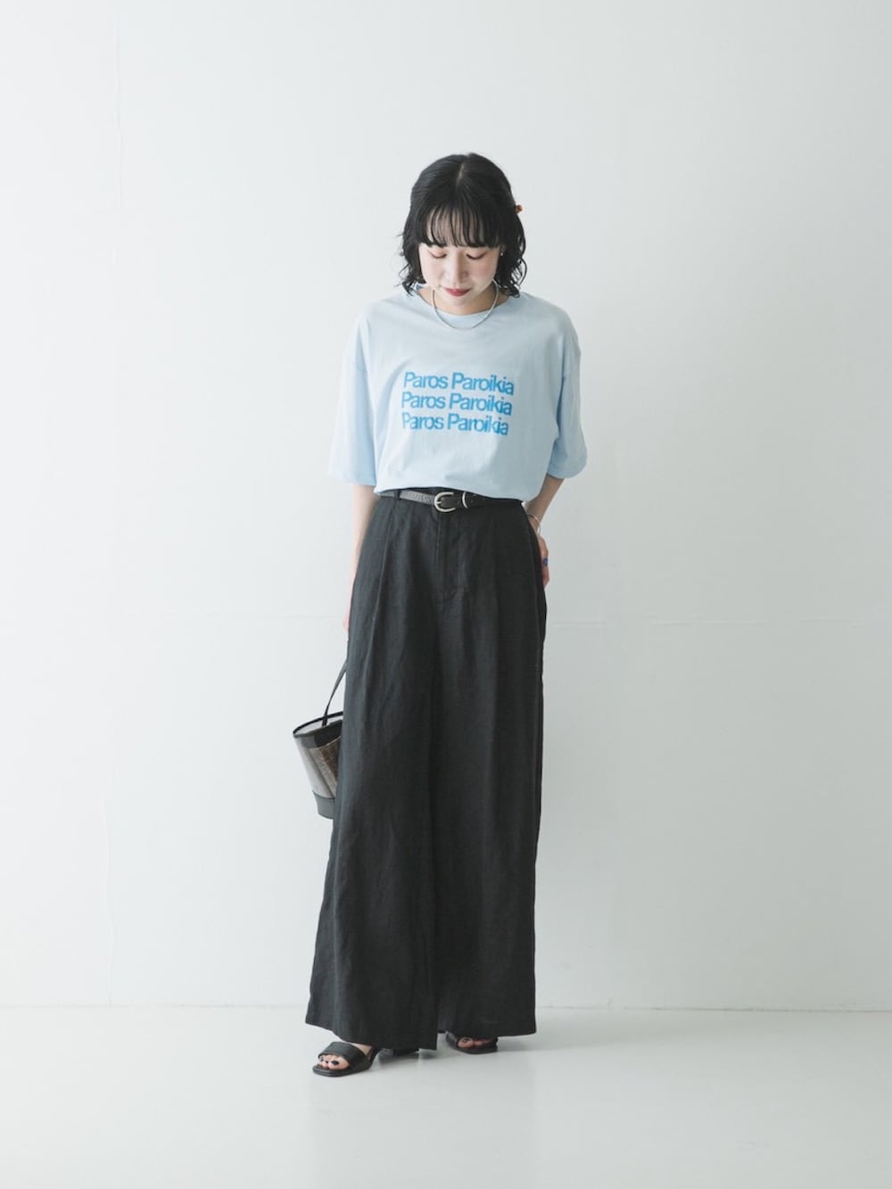 ブルー系のTシャツ/カットソー、ブラック系のかごバッグ、ブラック系のその他パンツを着用したレディースの春コーディネートの2枚目の写真