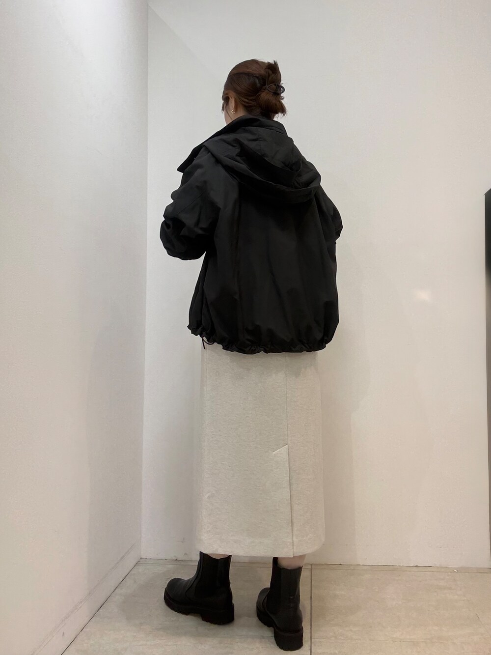 ホワイト系のTシャツ/カットソー、ホワイト系のスカート、ブラック系のブルゾンを着用したレディースの秋コーディネートの6枚目の写真