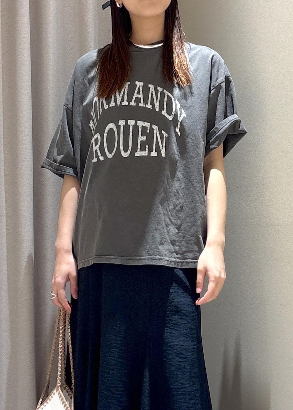 ホワイト系のハンドバッグ、ブルー系のスカート、グレー系のTシャツ/カットソーを着用したレディースの春コーディネートの5枚目の写真