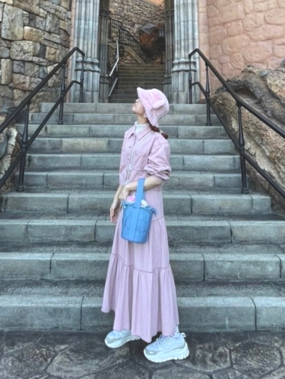 ピンク系のスカート、ピンク系のジャケット/アウター、ブルー系のハンドバッグを着用したレディースの秋コーディネートの3枚目の写真